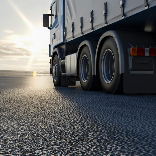 truck-is-driving-along-road-3d-image-3d-rendering